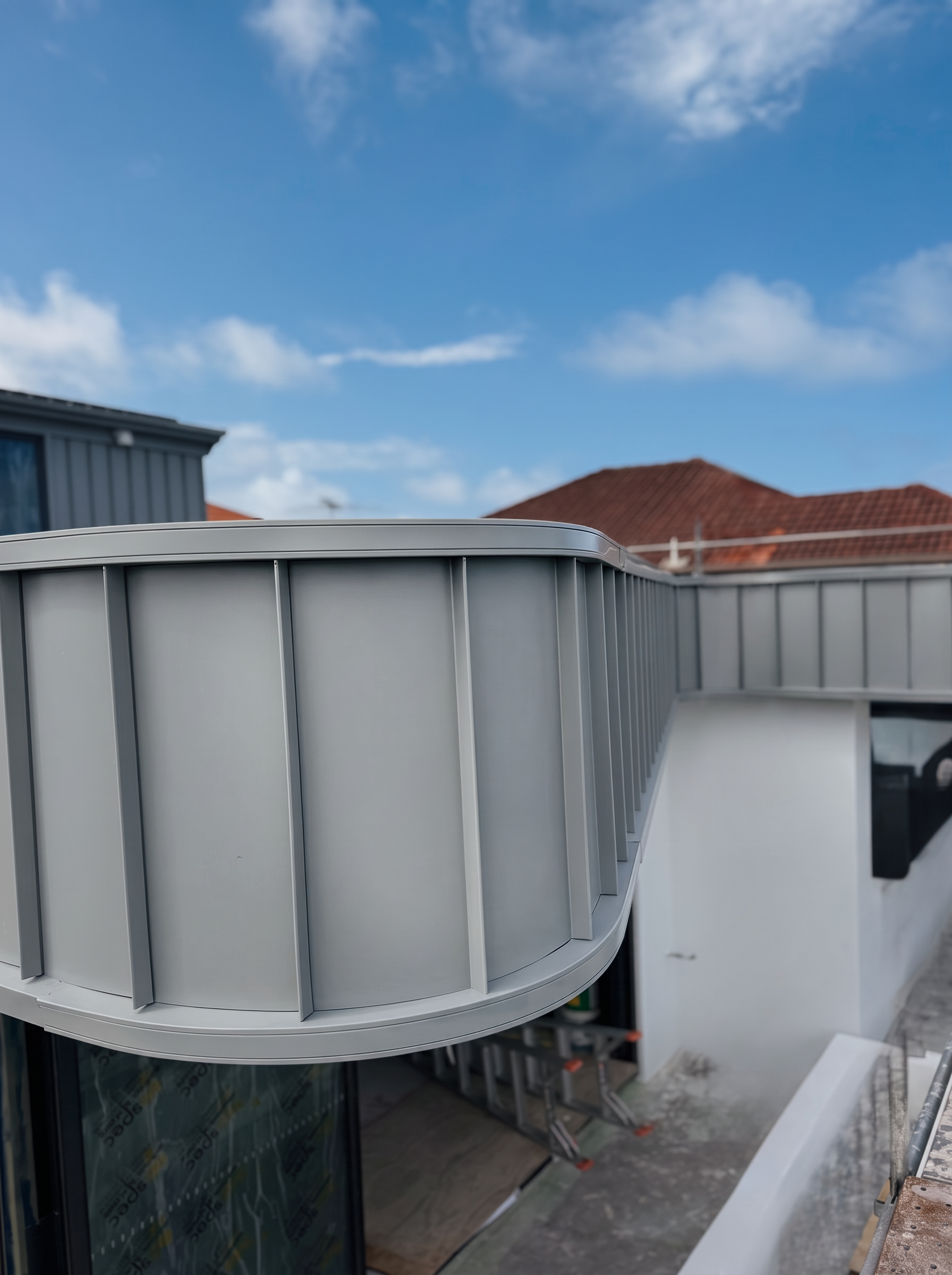 Bespoke curved standing seam metal cladding detail