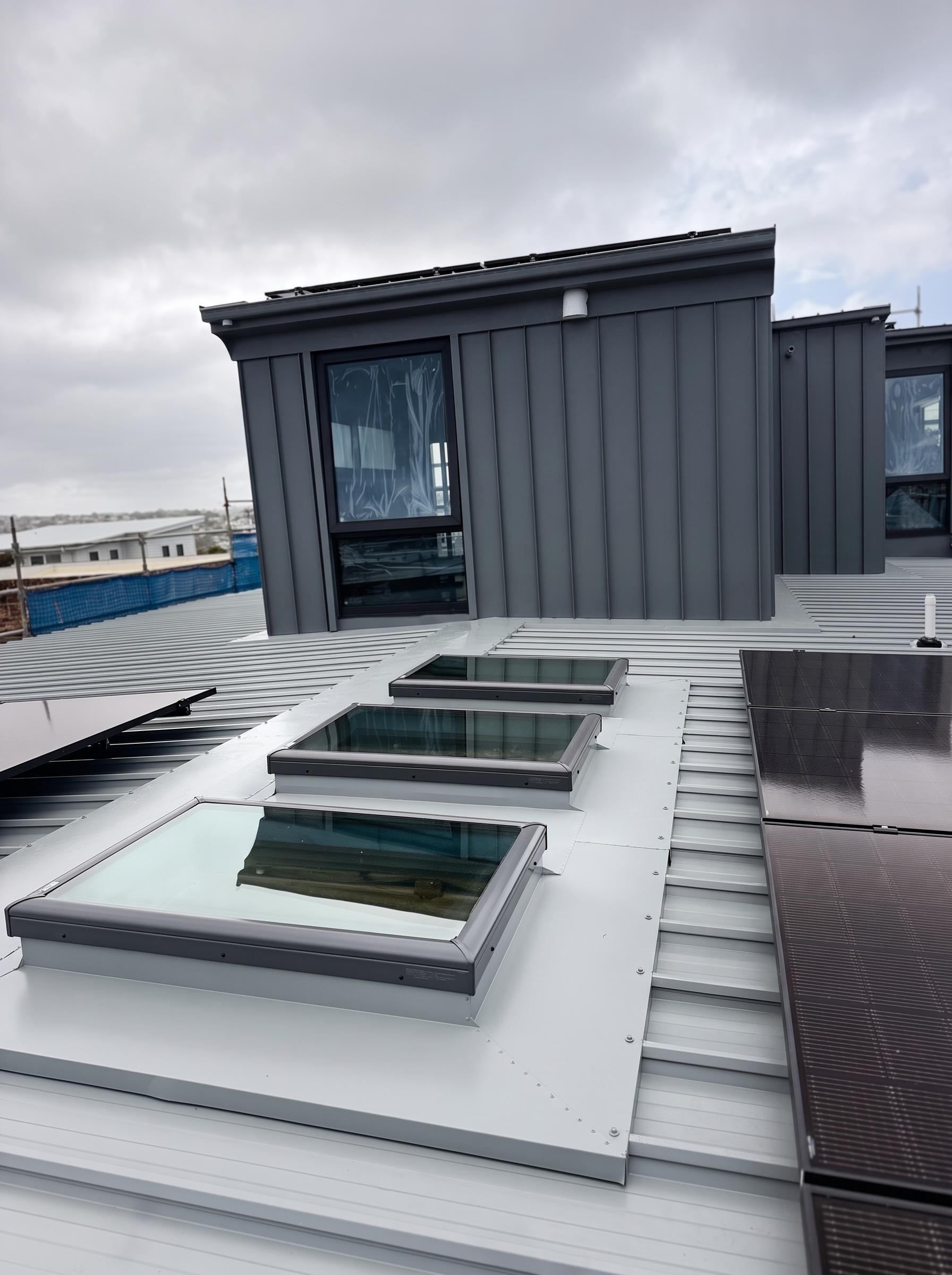 Completed metal roof with standing seam cladding, skylights and solar panels